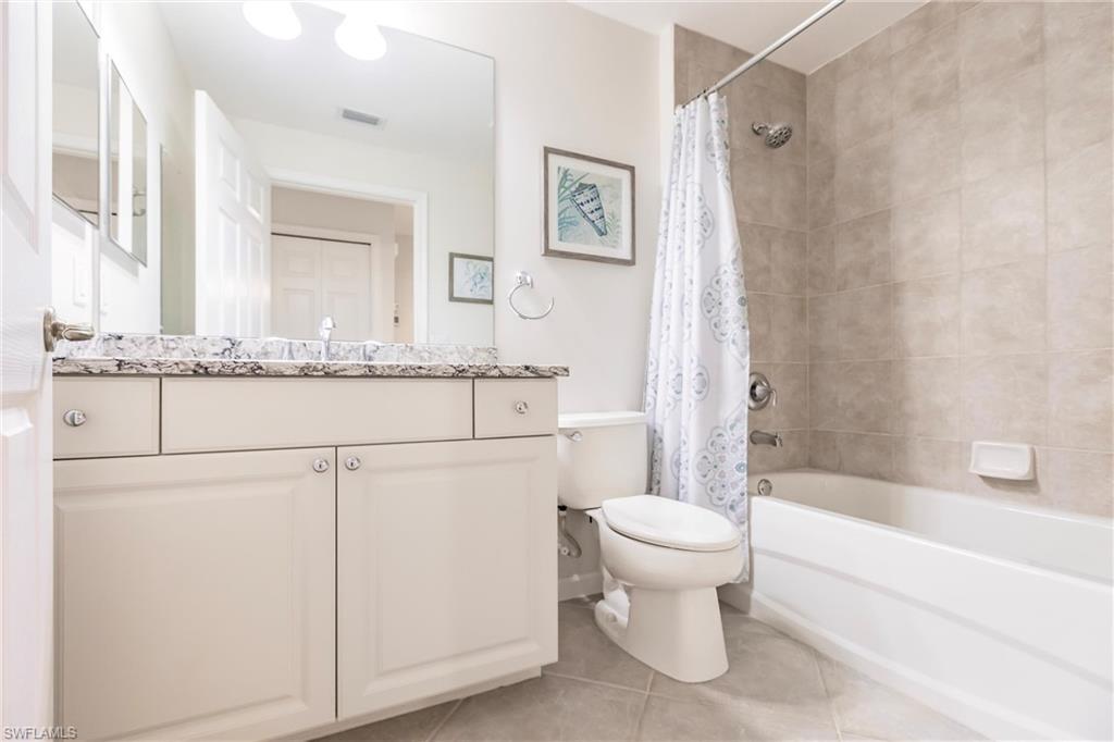 3071 Meandering Way, Unit 101 Fort Myers, FL 33905 - Photo 24 of 49 a bathroom with a granite countertop toilet sink and mirror