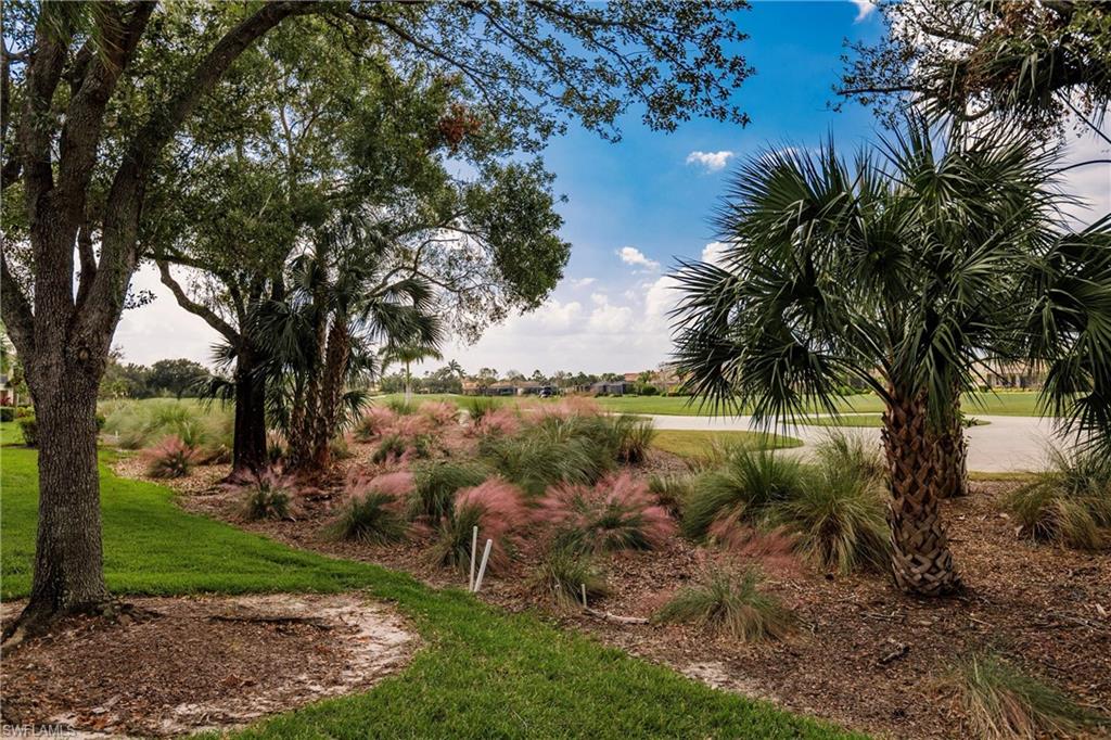 3071 Meandering Way, Unit 101 Fort Myers, FL 33905 - Photo 34 of 49 a view of a lake with a garden