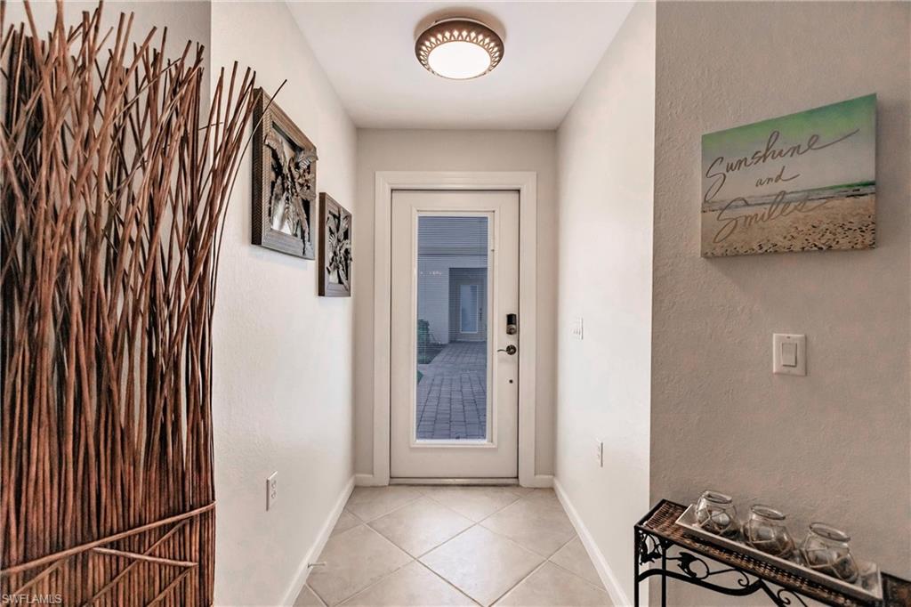 3071 Meandering Way, Unit 101 Fort Myers, FL 33905 - Photo 4 of 49 a view of an empty room with wooden floor