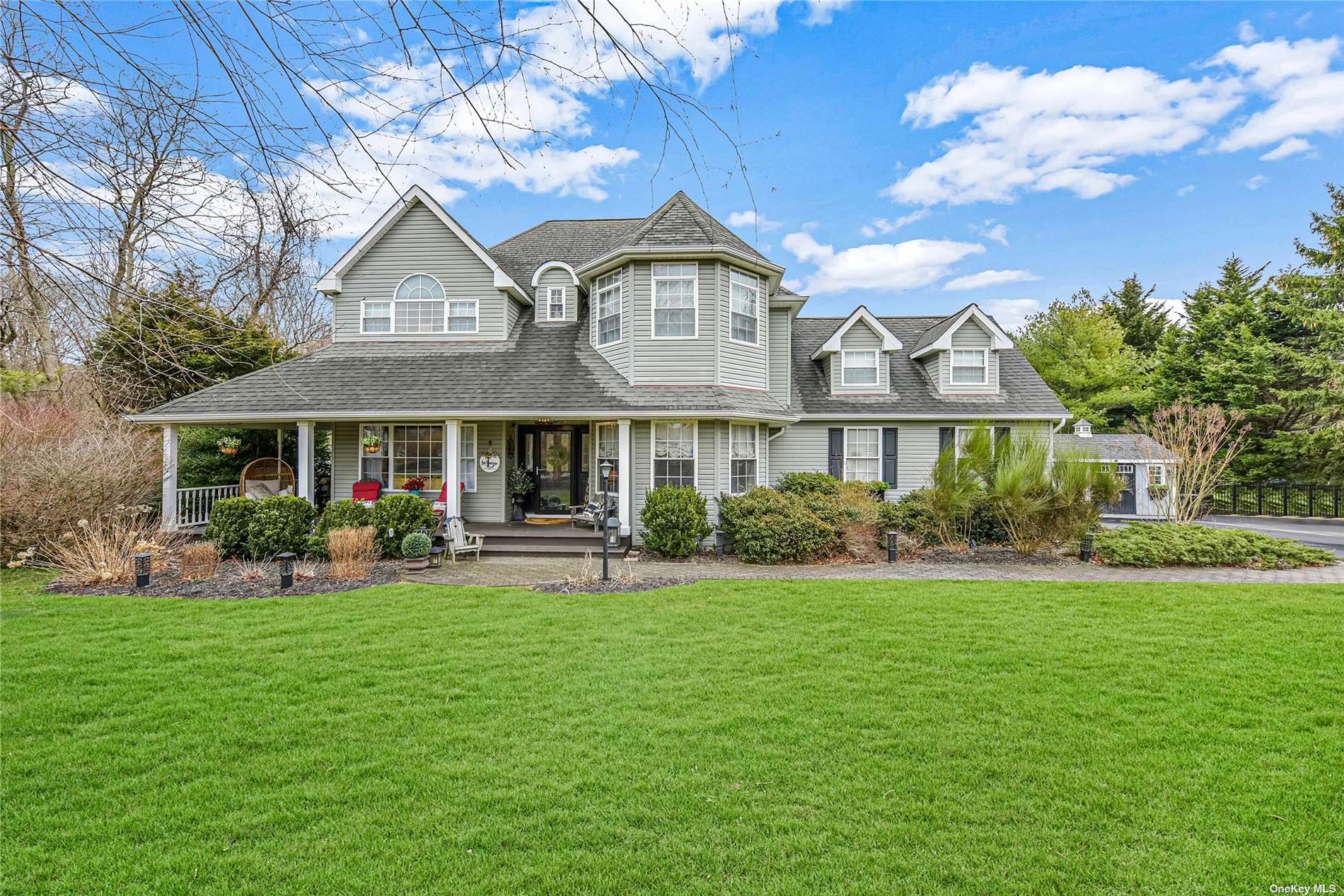 20 Manorage Road Manorville, NY 11949 - Photo 1 of 1 a front view of a house with garden and porch