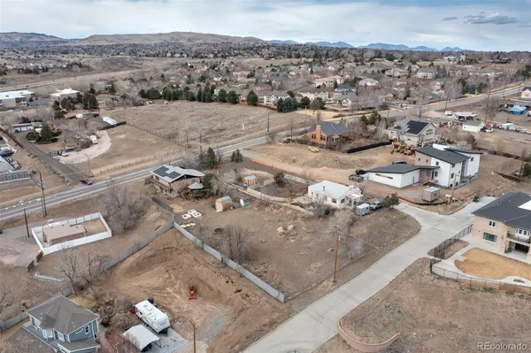 an aerial view of a house with a mountain