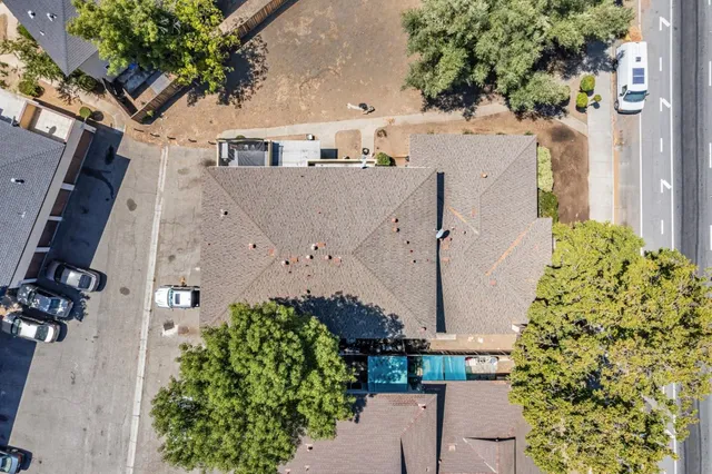 an aerial view of a house with a yard and garden