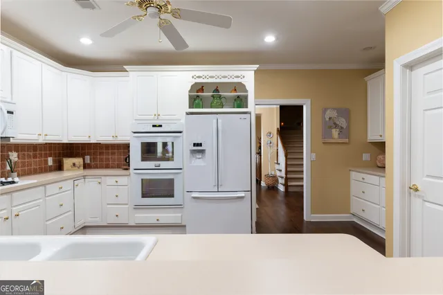 a kitchen with a refrigerator and a sink