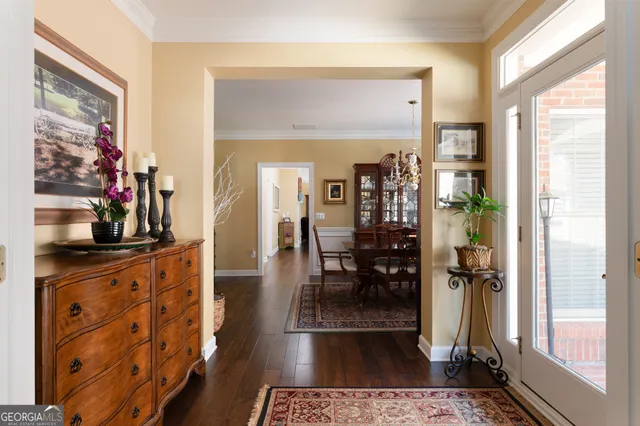 a hallway with dining table and chairs