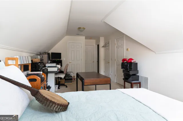 a bed room with a bed furniture and a flat screen tv
