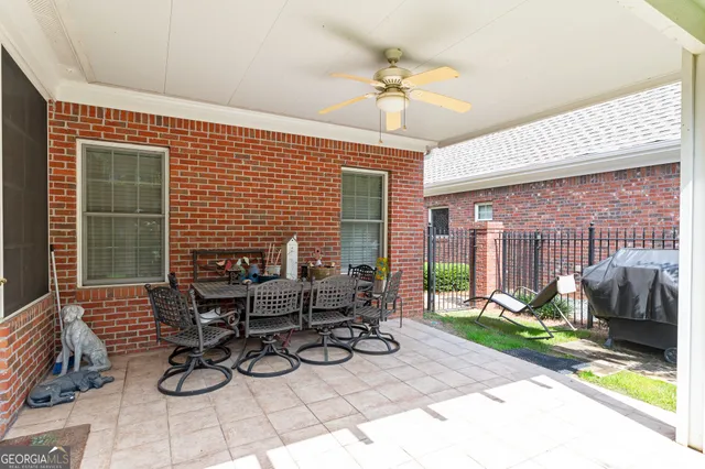 a view of a patio with couple of chairs and a table