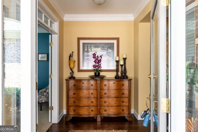 a view of a hallway with a cabinet and mirror