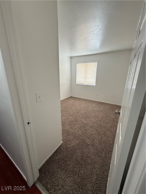 800 North Major Avenue Henderson, NV 89015 - Photo 16 of 18 Empty room featuring dark carpet and a textured ce