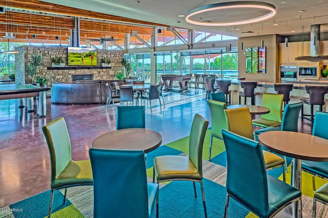 a dining room with furniture a rug and a floor to ceiling window