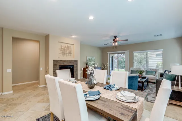 a dining room with furniture window and wooden floor