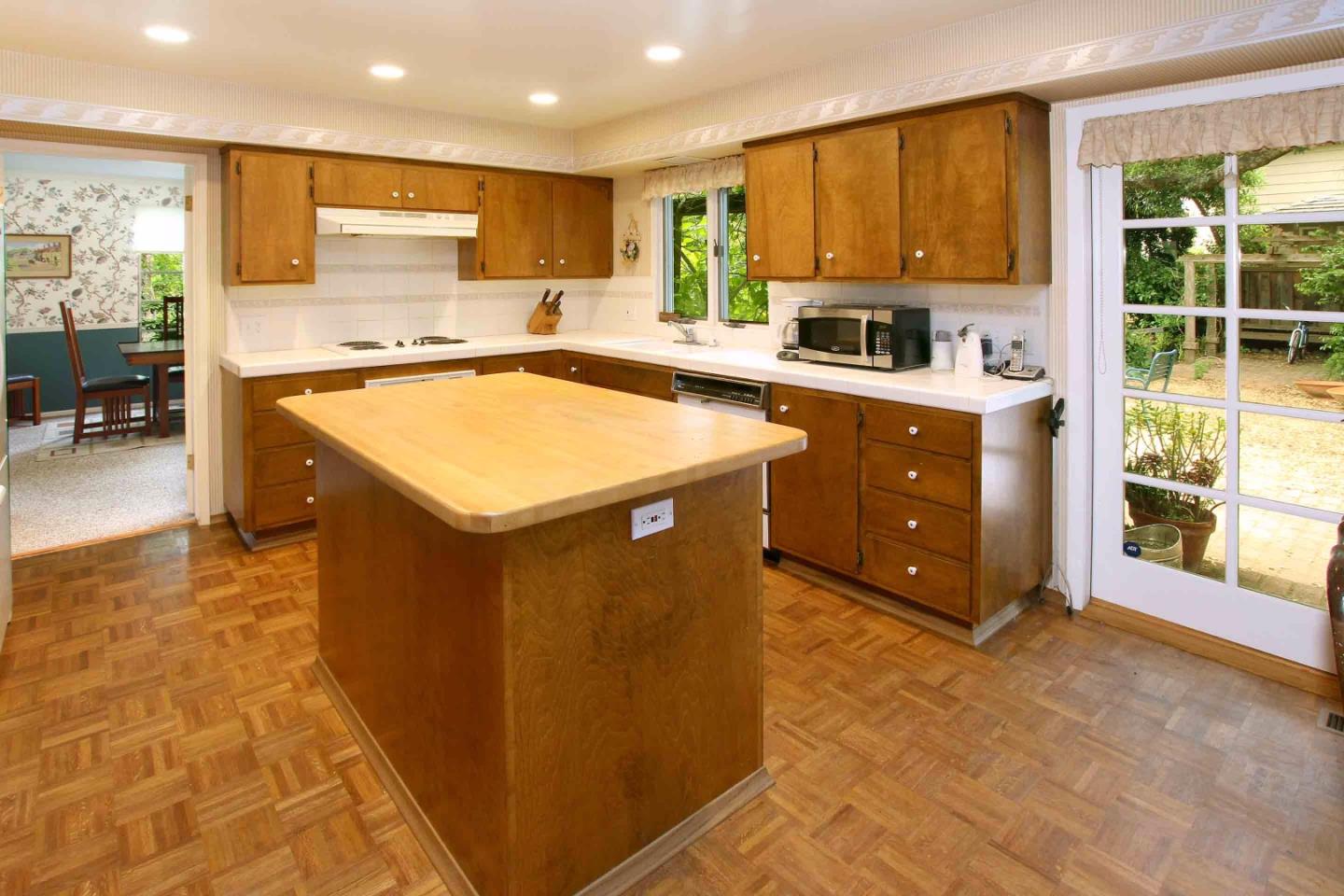 21 Oak Road Santa Cruz, CA 95060 - Photo 7 of 25 a kitchen with kitchen island granite countertop a stove a sink a counter top space and cabinets