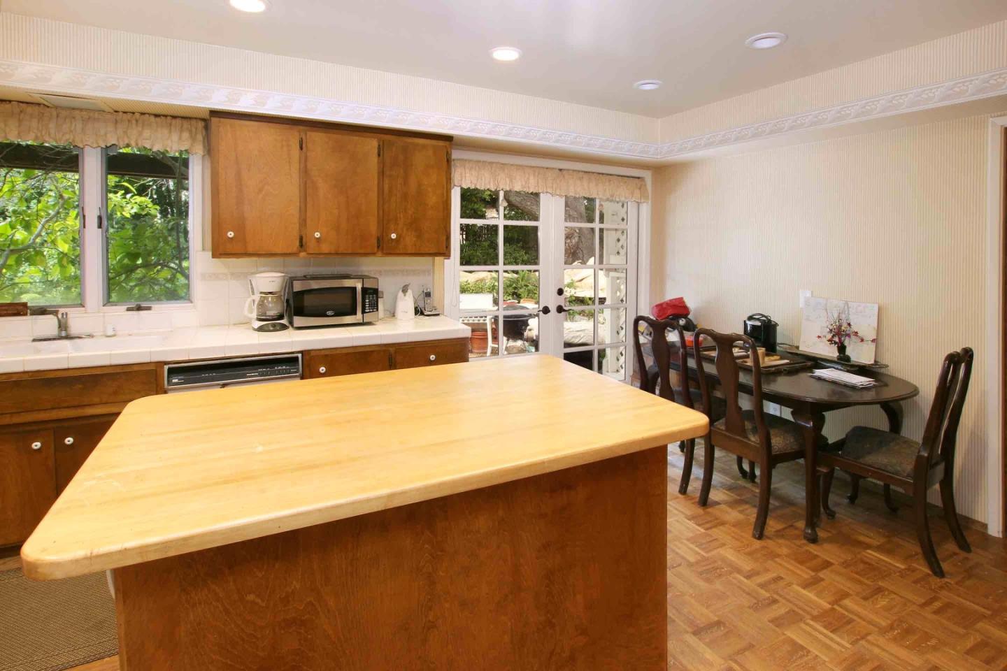 21 Oak Road Santa Cruz, CA 95060 - Photo 8 of 25 a kitchen with a table chairs sink and cabinets