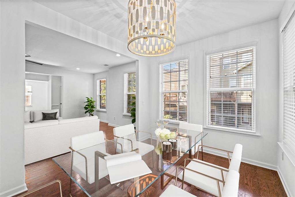 4228 Laurel Creek Court Southeast, Unit 6 Smyrna, GA 30080 - Photo 11 of 59 a dining room with furniture a chandelier and wooden floor