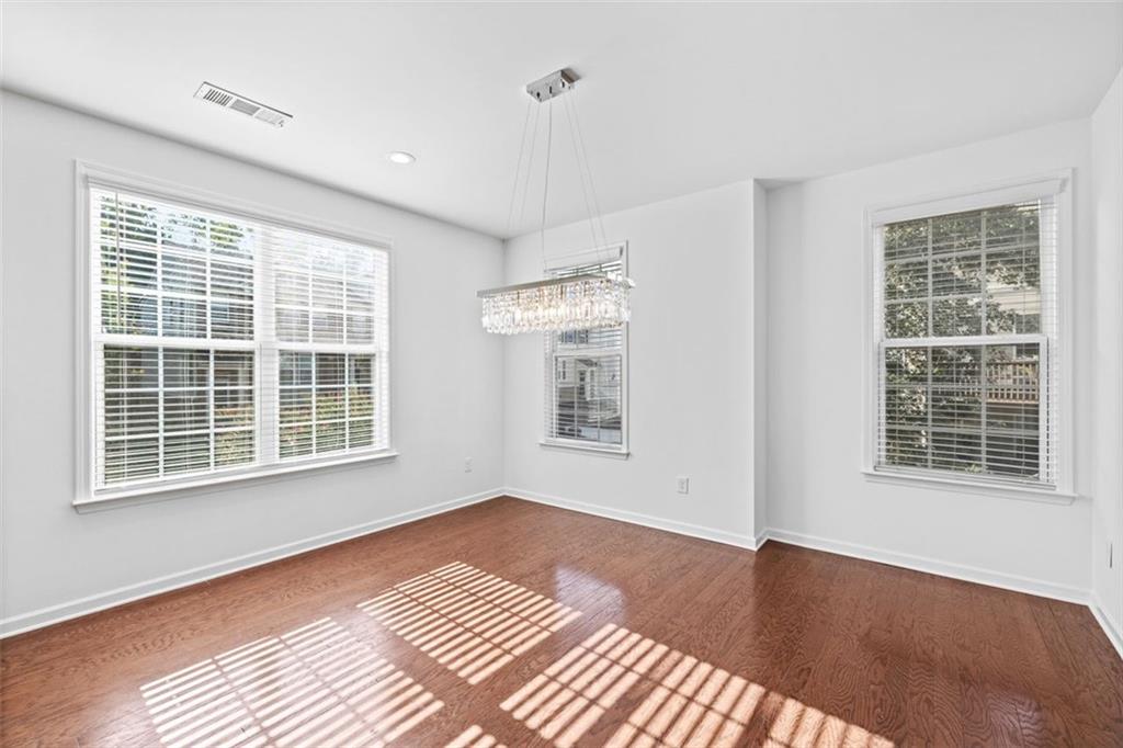 4228 Laurel Creek Court Southeast, Unit 6 Smyrna, GA 30080 - Photo 13 of 59 a view of an empty room with a window and wooden floor