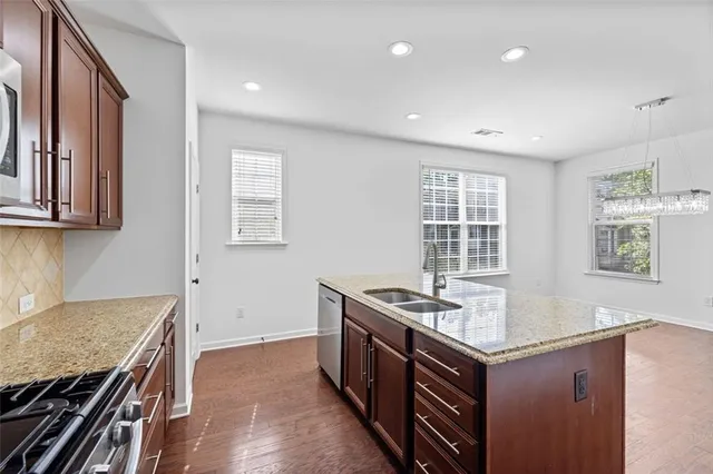 a kitchen with a stove a refrigerator and a sink