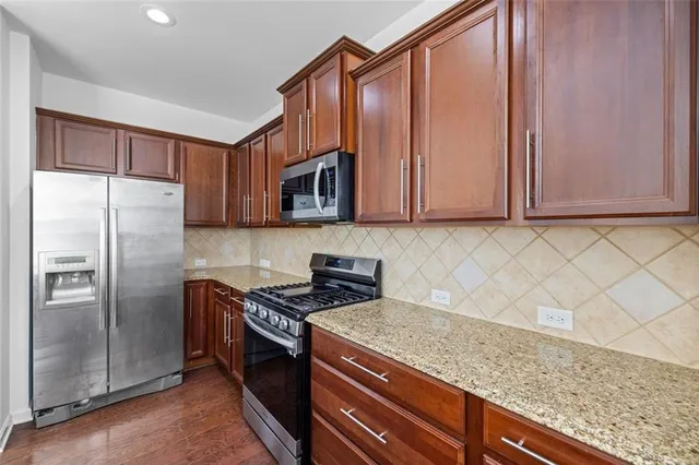 a kitchen with a stove a sink and a refrigerator