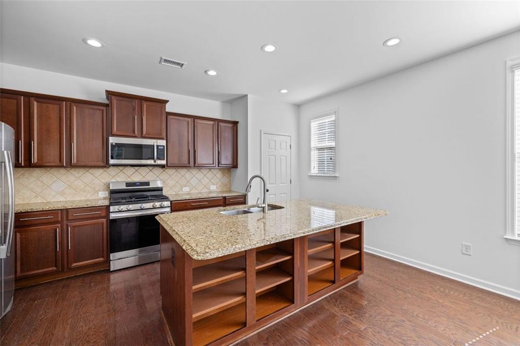 4228 Laurel Creek Court Southeast, Unit 6 Smyrna, GA 30080 - Photo 19 of 59 a kitchen with a stove a sink and a refrigerator