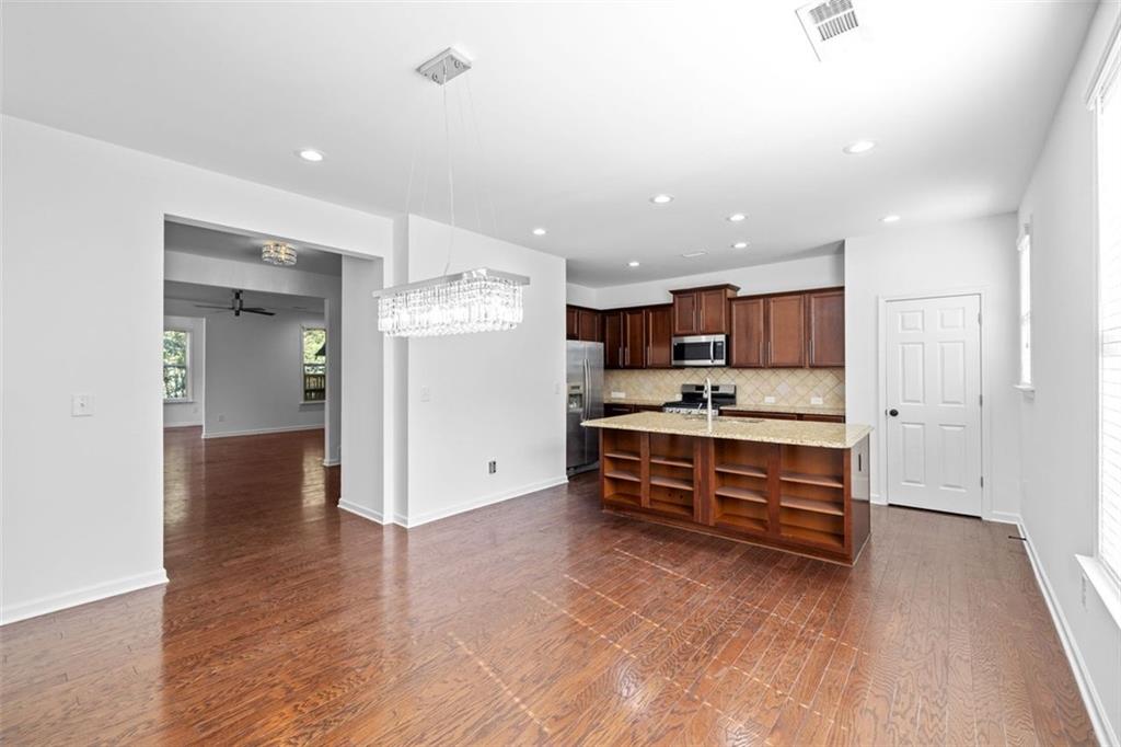 4228 Laurel Creek Court Southeast, Unit 6 Smyrna, GA 30080 - Photo 21 of 59 a view of kitchen with stainless steel appliances kitchen island wooden floor and view living room