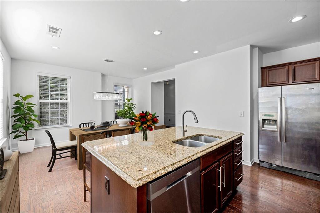 4228 Laurel Creek Court Southeast, Unit 6 Smyrna, GA 30080 - Photo 22 of 59 a kitchen with granite countertop a sink chairs and refrigerator