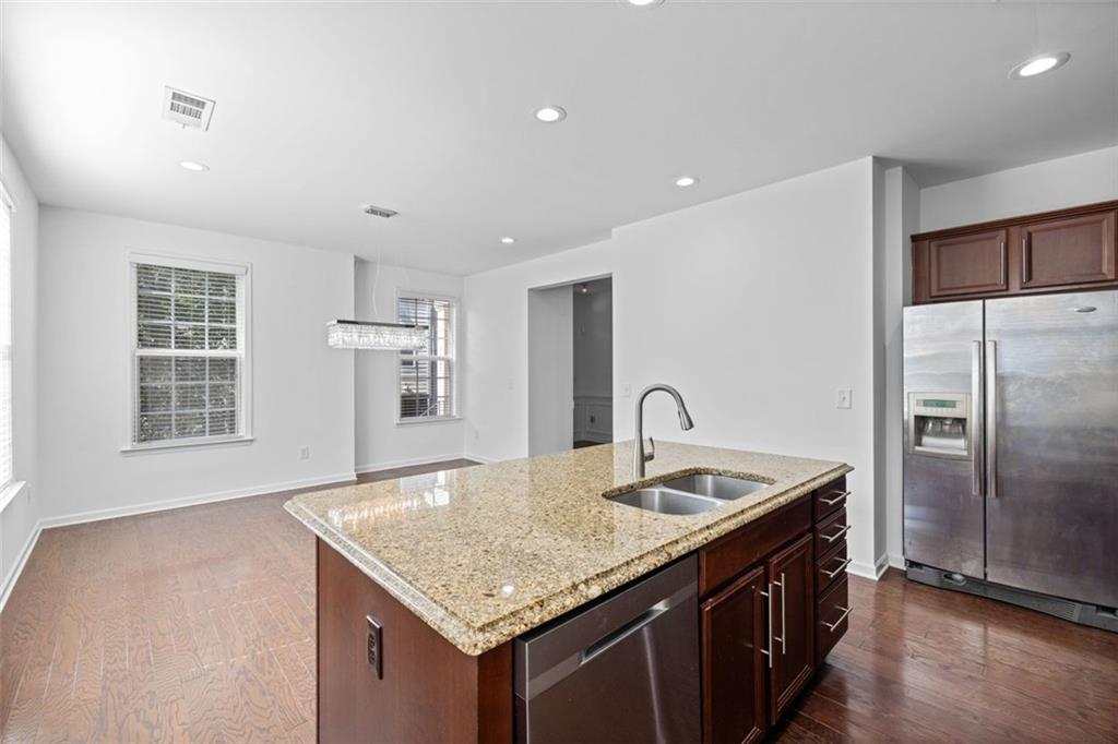 4228 Laurel Creek Court Southeast, Unit 6 Smyrna, GA 30080 - Photo 23 of 59 a kitchen with kitchen island granite countertop a sink and refrigerator