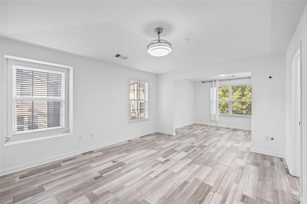 4228 Laurel Creek Court Southeast, Unit 6 Smyrna, GA 30080 - Photo 25 of 59 a view of an empty room with a window and wooden floor