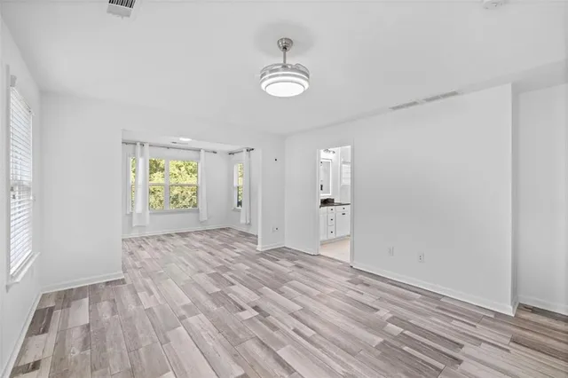 a view of a room with window and hardwood floor