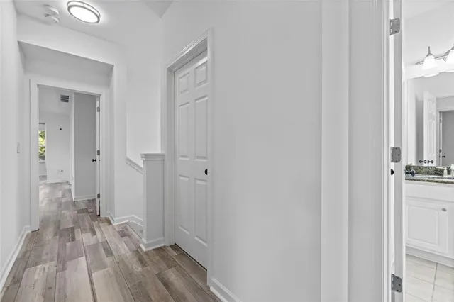a view of a room with wooden floor and fan