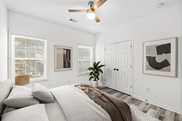 a view of empty room with window and ceiling fan