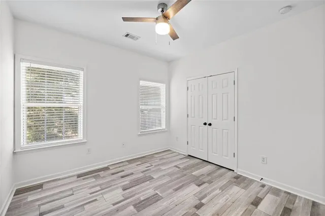 a bathroom with a granite countertop sink a toilet and bathtub