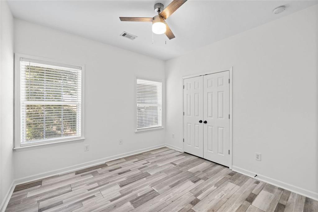 4228 Laurel Creek Court Southeast, Unit 6 Smyrna, GA 30080 - Photo 38 of 59 a view of empty room with wooden floor and fan