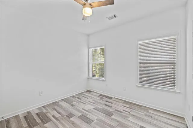 a view of a livingroom with a ceiling fan and wooden floor