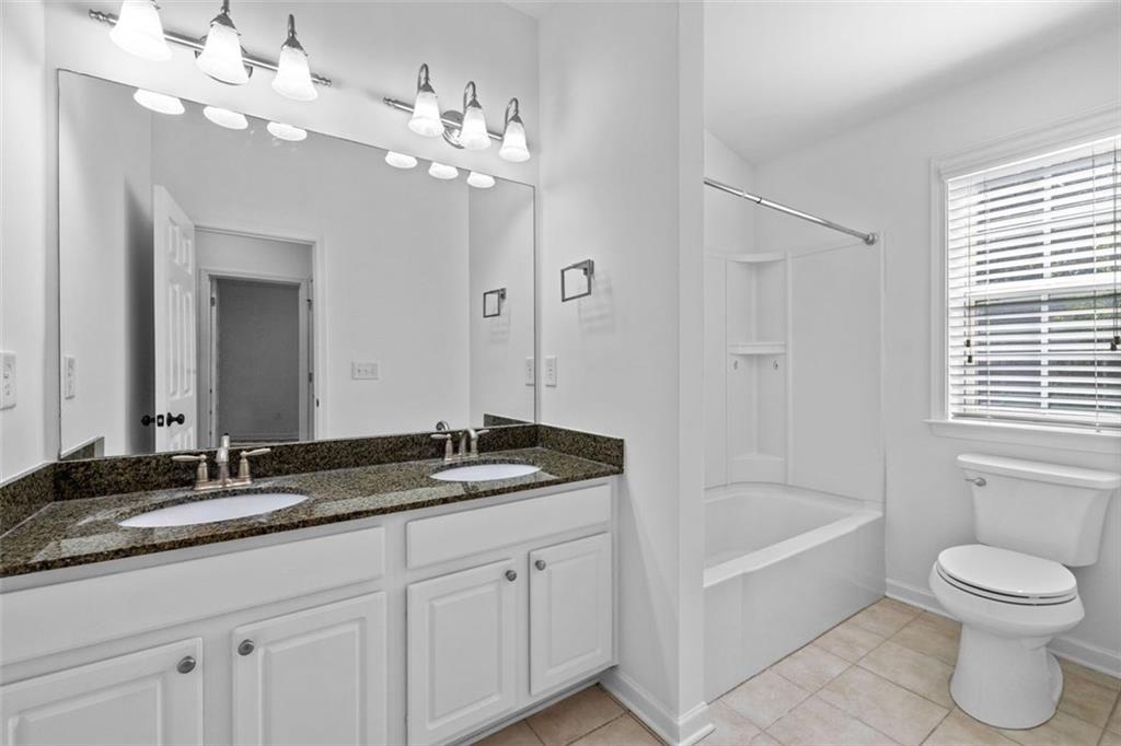 4228 Laurel Creek Court Southeast, Unit 6 Smyrna, GA 30080 - Photo 42 of 59 a bathroom with a granite countertop sink a toilet and bathtub