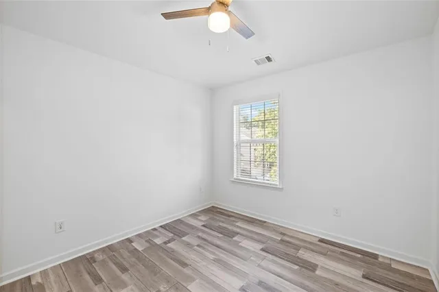 a view of a room with wooden floor and white walls