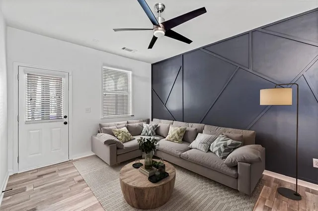 a view of a house with a yard and large tree