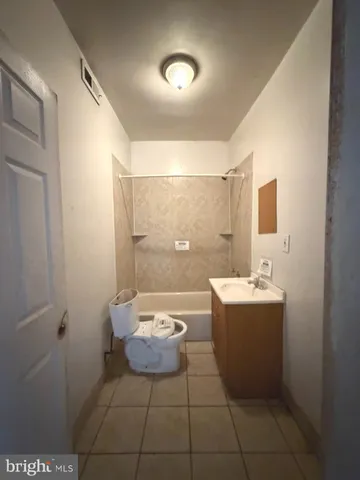 a spacious bathroom with a toilet a sink and mirror