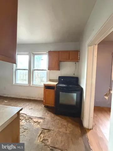 a kitchen with granite countertop a stove and a refrigerator