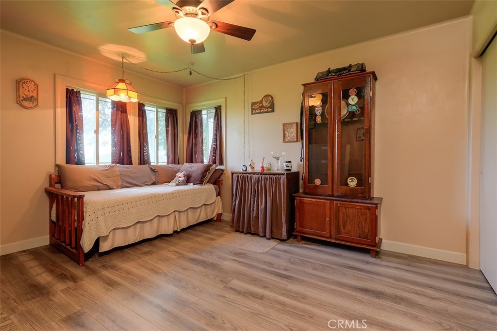 23256 Richfield Road Corning, CA 96021 - Photo 21 of 60 a spacious bedroom with a bed and wooden floor