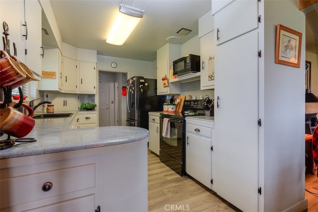 23256 Richfield Road Corning, CA 96021 - Photo 10 of 60 a kitchen with stainless steel appliances a refrigerator sink and cabinets