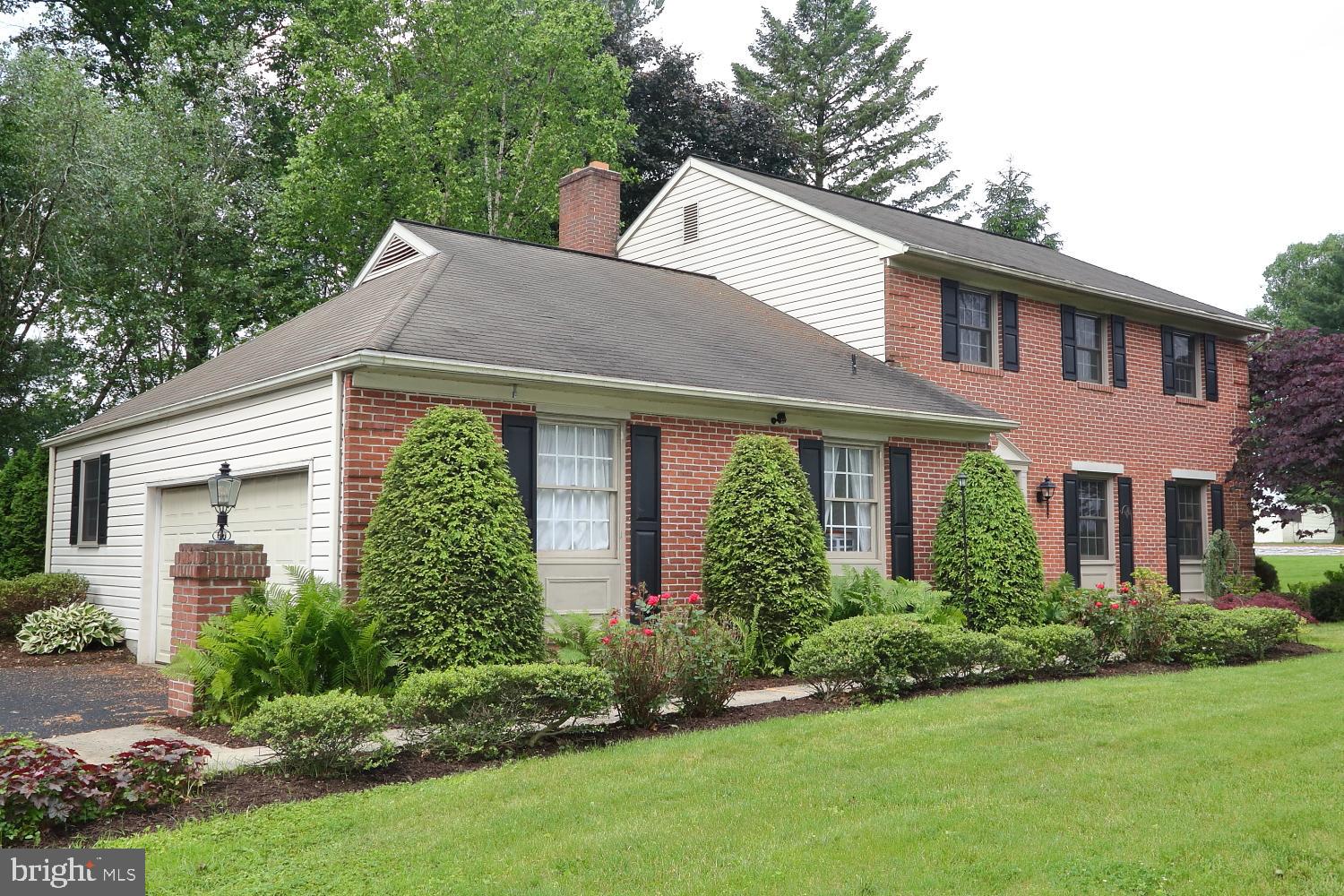 235 St Thomas Road Lancaster, PA 17601 - Photo 1 of 32 a view of a house with brick walls and a yard with plants