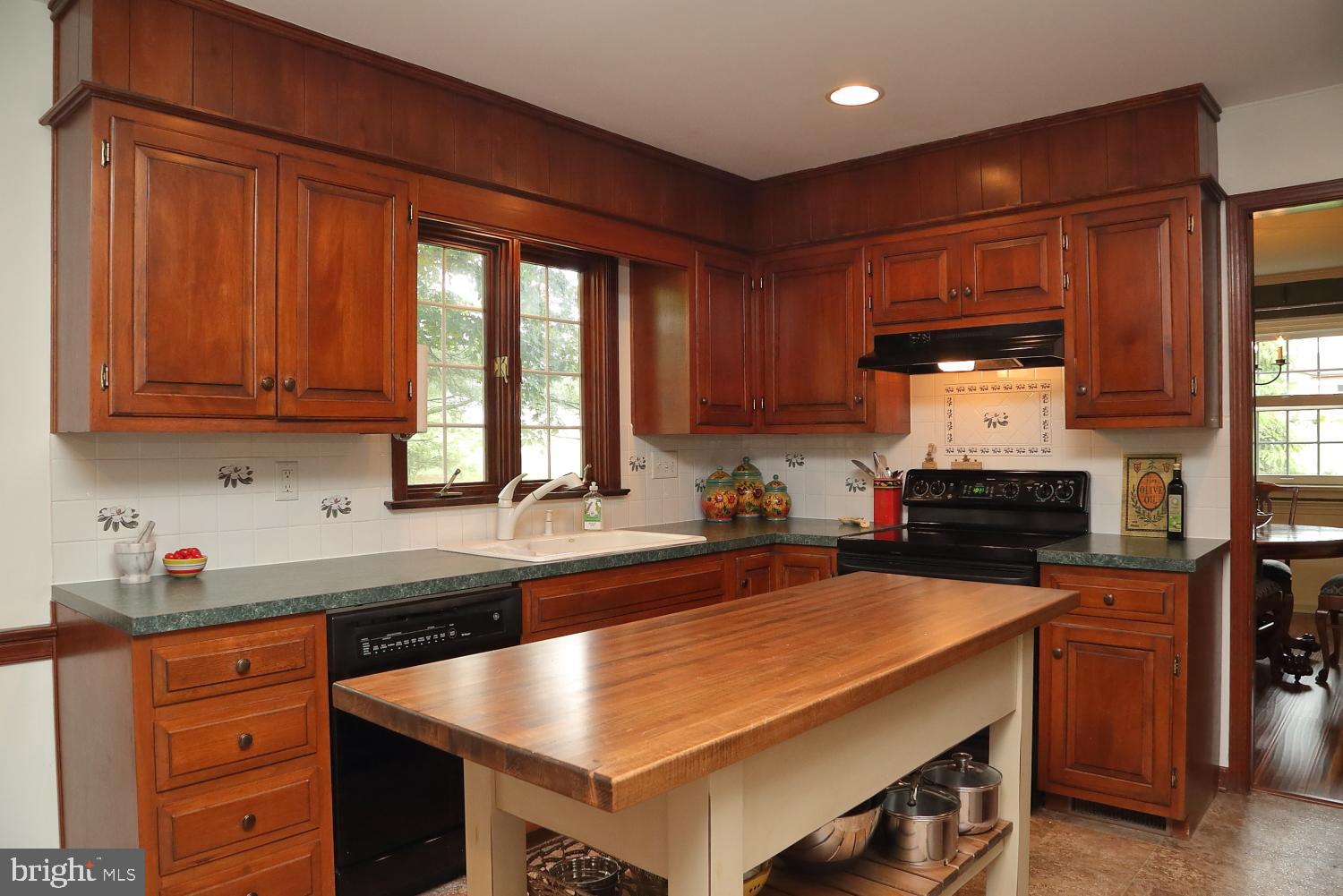 235 St Thomas Road Lancaster, PA 17601 - Photo 11 of 32 a kitchen with granite countertop a sink stainless steel appliances wooden cabinets and a counter top space
