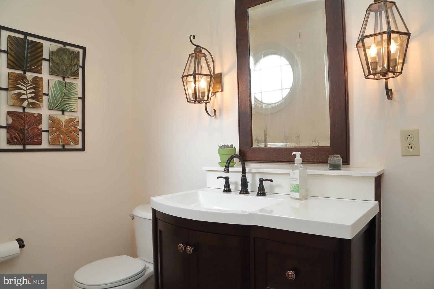 235 St Thomas Road Lancaster, PA 17601 - Photo 9 of 32 a bathroom with a toilet sink vanity and mirror