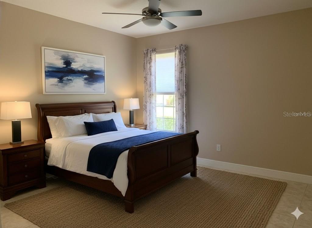 5409 Sunset Falls Drive Apollo Beach, FL 33572 - Photo 20 of 46 a spacious bedroom with a bed and a window