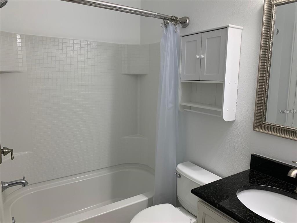 5409 Sunset Falls Drive Apollo Beach, FL 33572 - Photo 21 of 46 a bathroom with a granite countertop toilet sink and shower