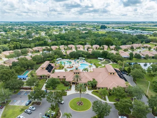 a view of a swimming pool with a patio and garden
