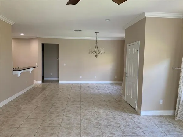 a view of a big room with wooden cabinet and windows