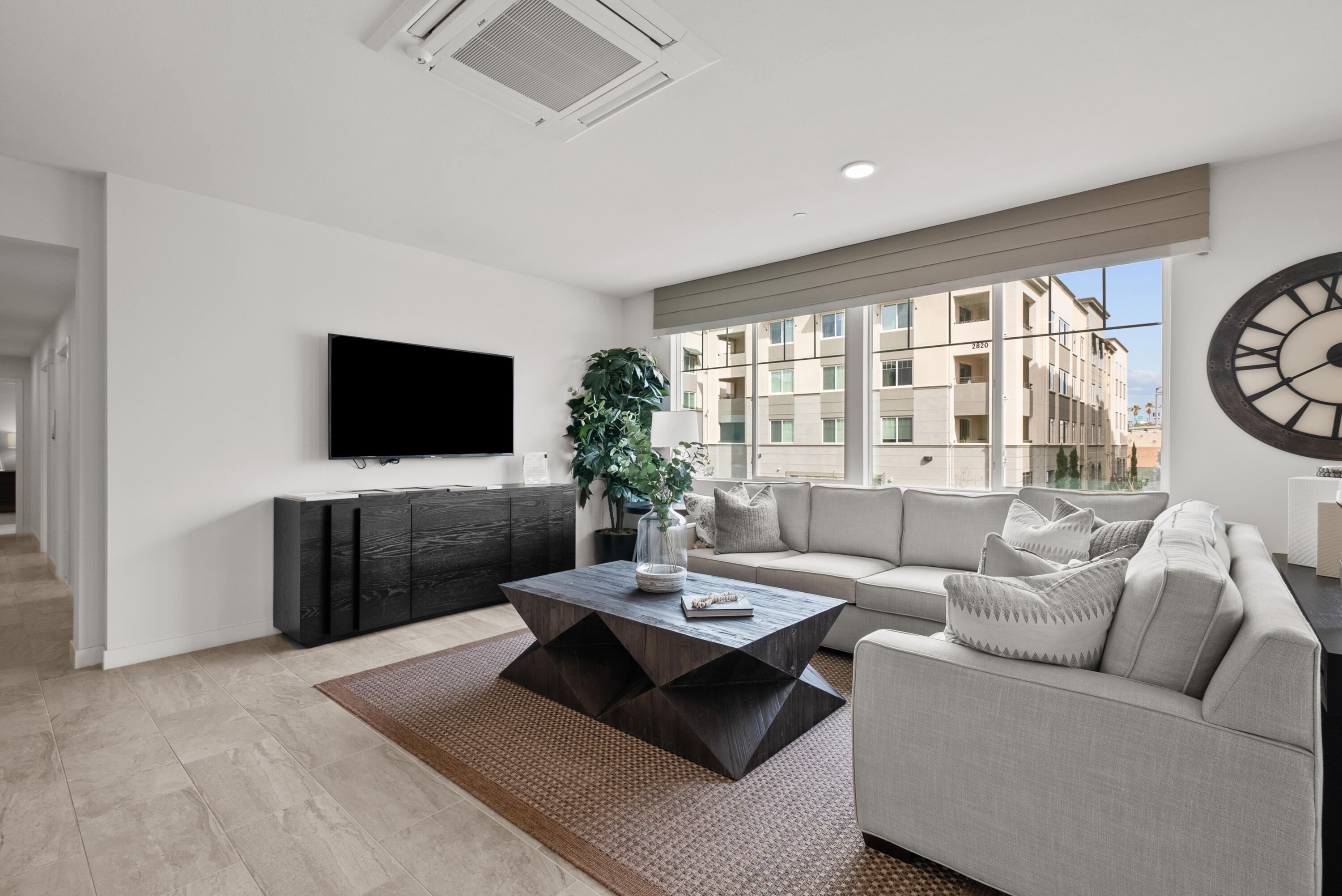 2840 Wagon Wheel Road, Unit 403 Oxnard, CA 93036 - Photo 3 of 23 a living room with furniture a flat screen tv and a large window
