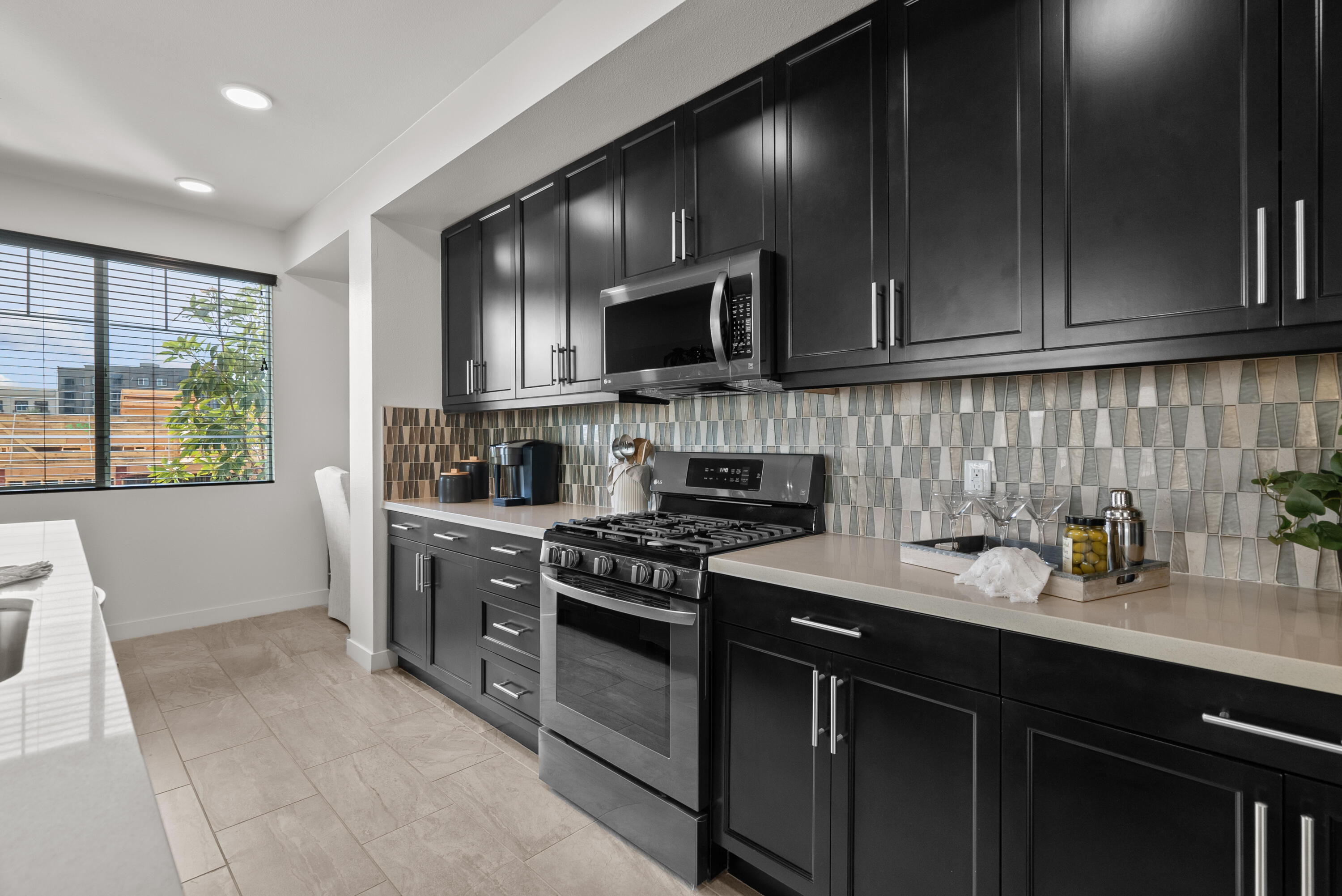 2840 Wagon Wheel Road, Unit 403 Oxnard, CA 93036 - Photo 8 of 23 a kitchen with a sink stove top oven and cabinets