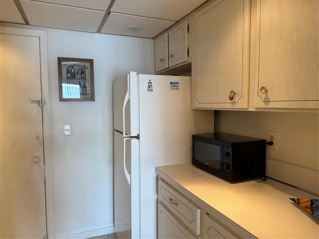 a kitchen with a refrigerator and cabinets