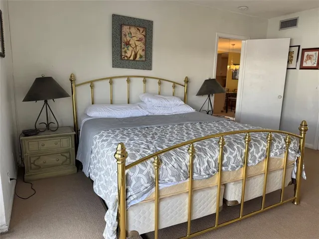 a bedroom with a bed and a chair