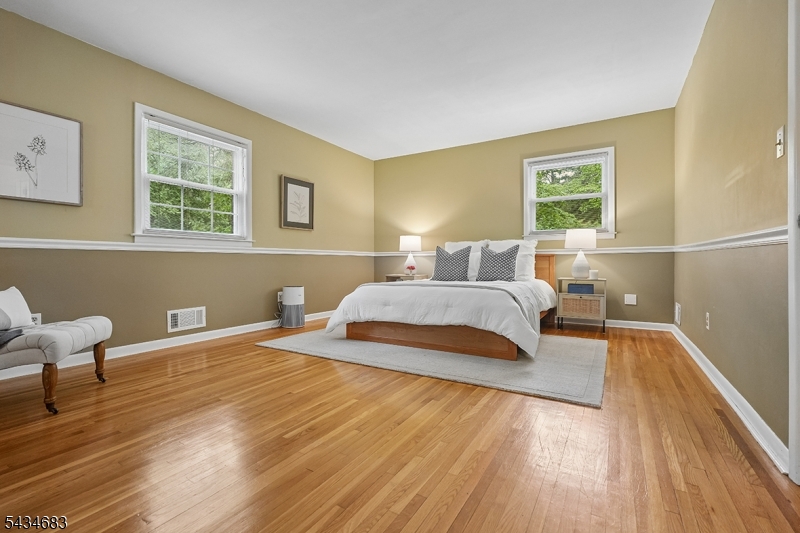 106 Division Avenue Summit, NJ 07901 - Photo 17 of 38 a bedroom with a bed and a chair